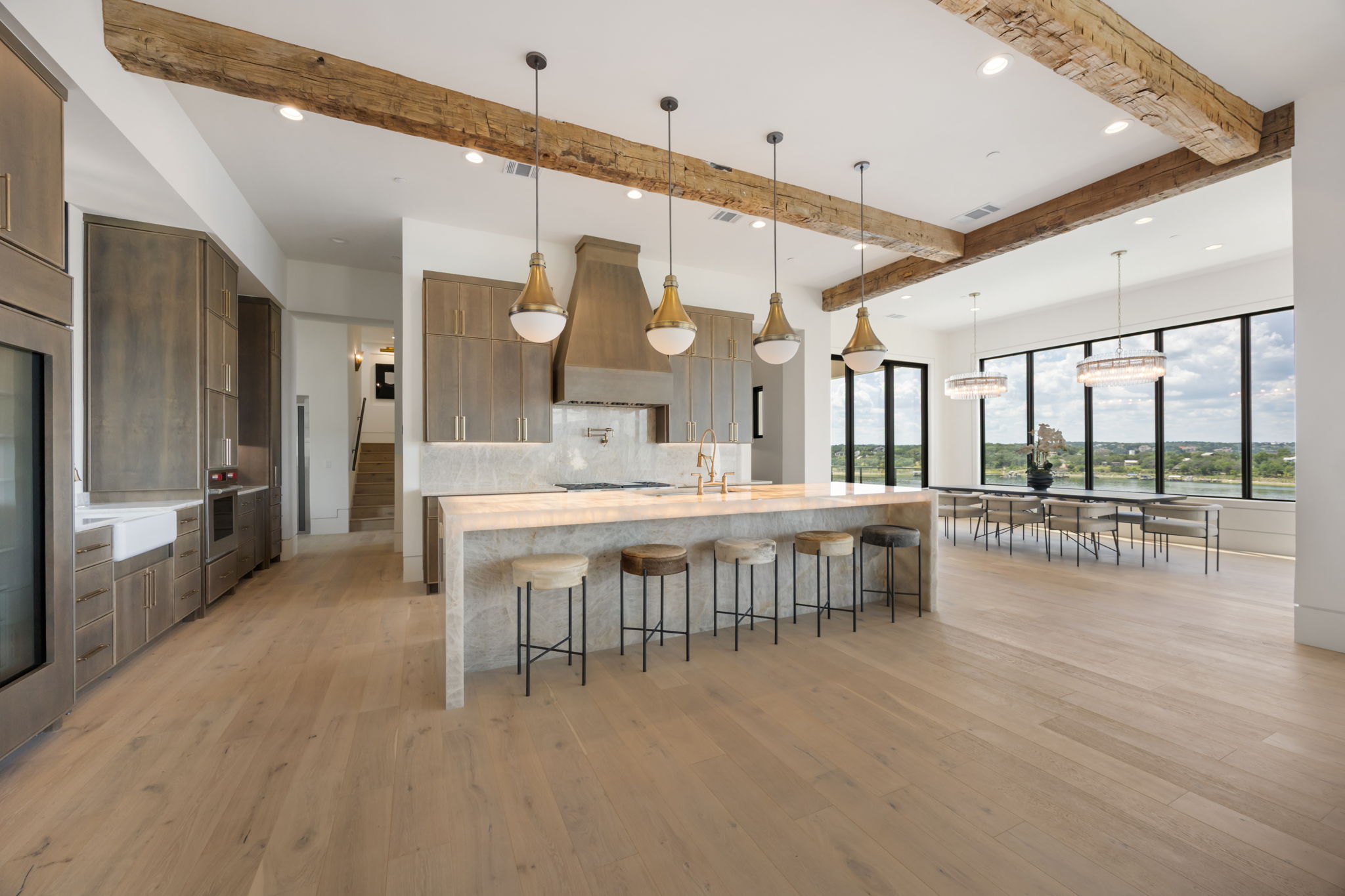 1496 Buffalo Gap Road Lakeway, TX 78734 - Photo 6 of 37 Exposed wood beams crown this gourmet kitchen with a grand island and a dining area, all overlooking tranquil waters.