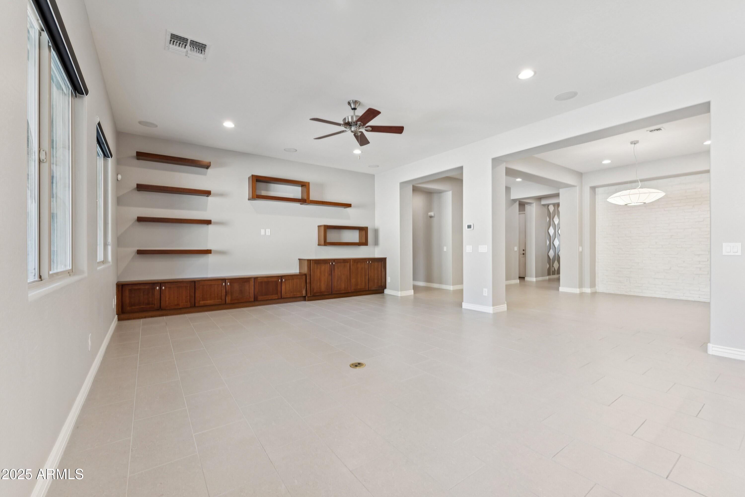 9916 West Redbird Road Peoria, AZ 85383 - Photo 14 of 96 wooden floor in an empty room with a ceiling fan