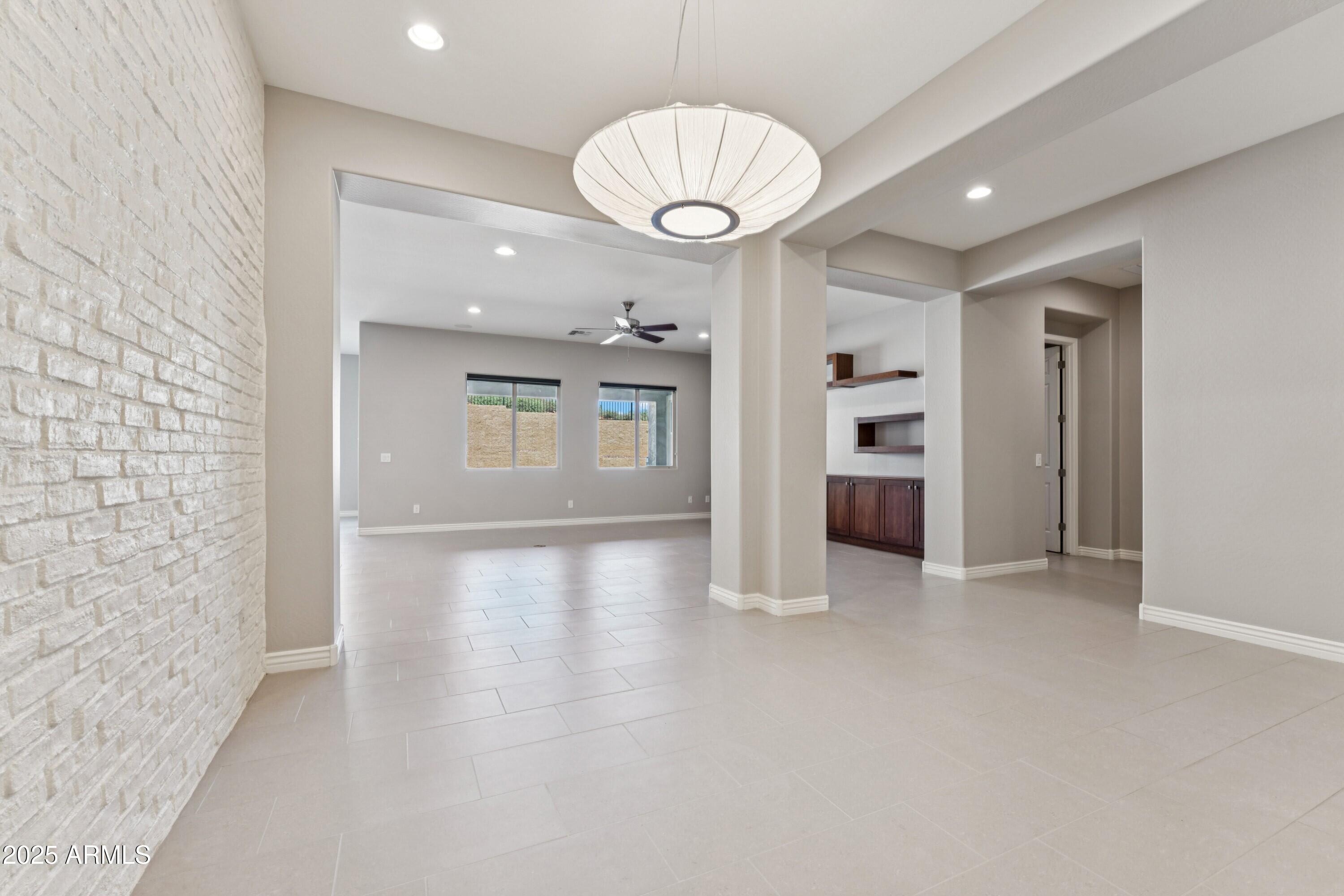 9916 West Redbird Road Peoria, AZ 85383 - Photo 16 of 96 wooden floor in an empty room with a mirror