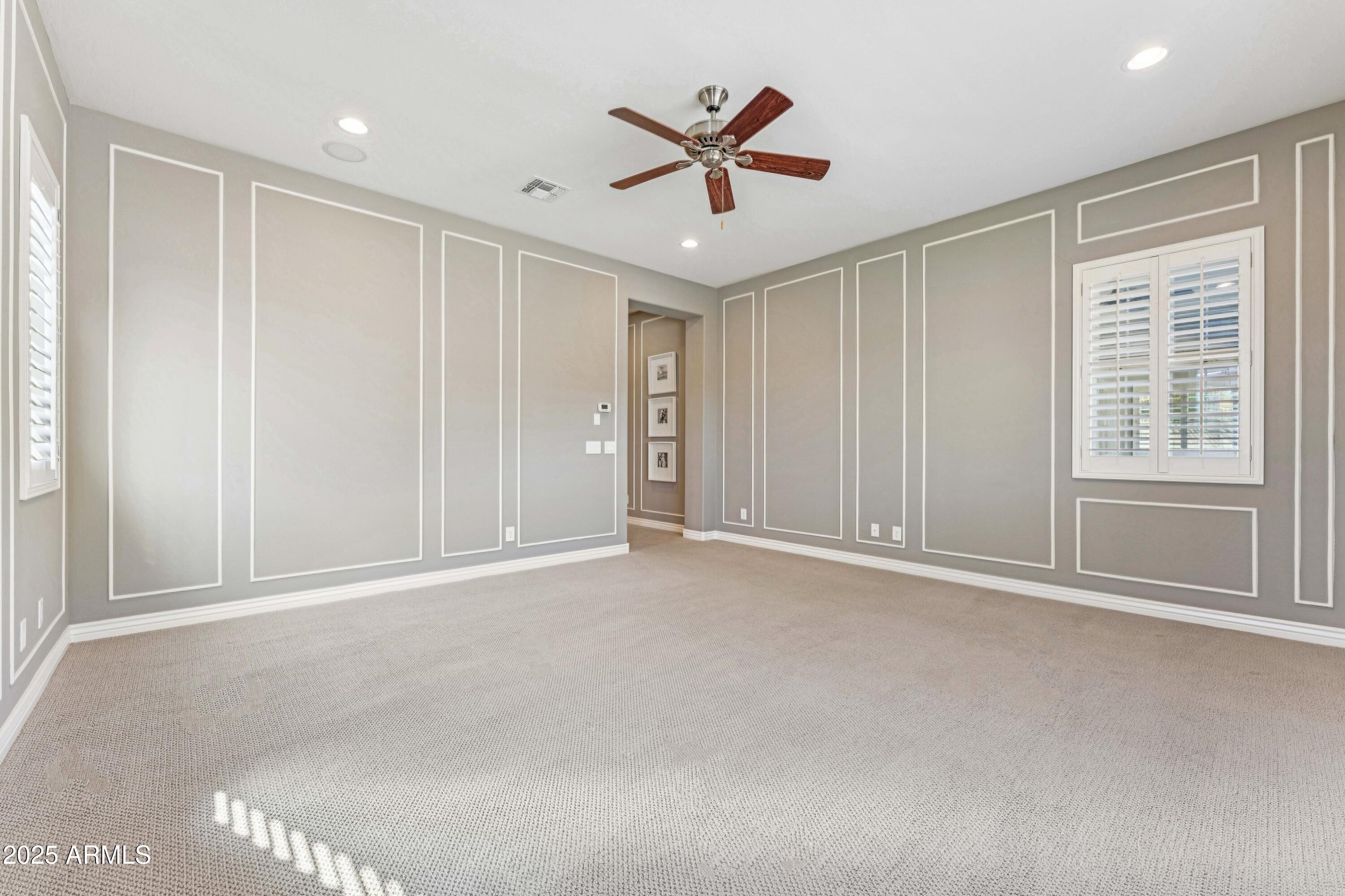 9916 West Redbird Road Peoria, AZ 85383 - Photo 20 of 96 an empty room with window and ceiling fan