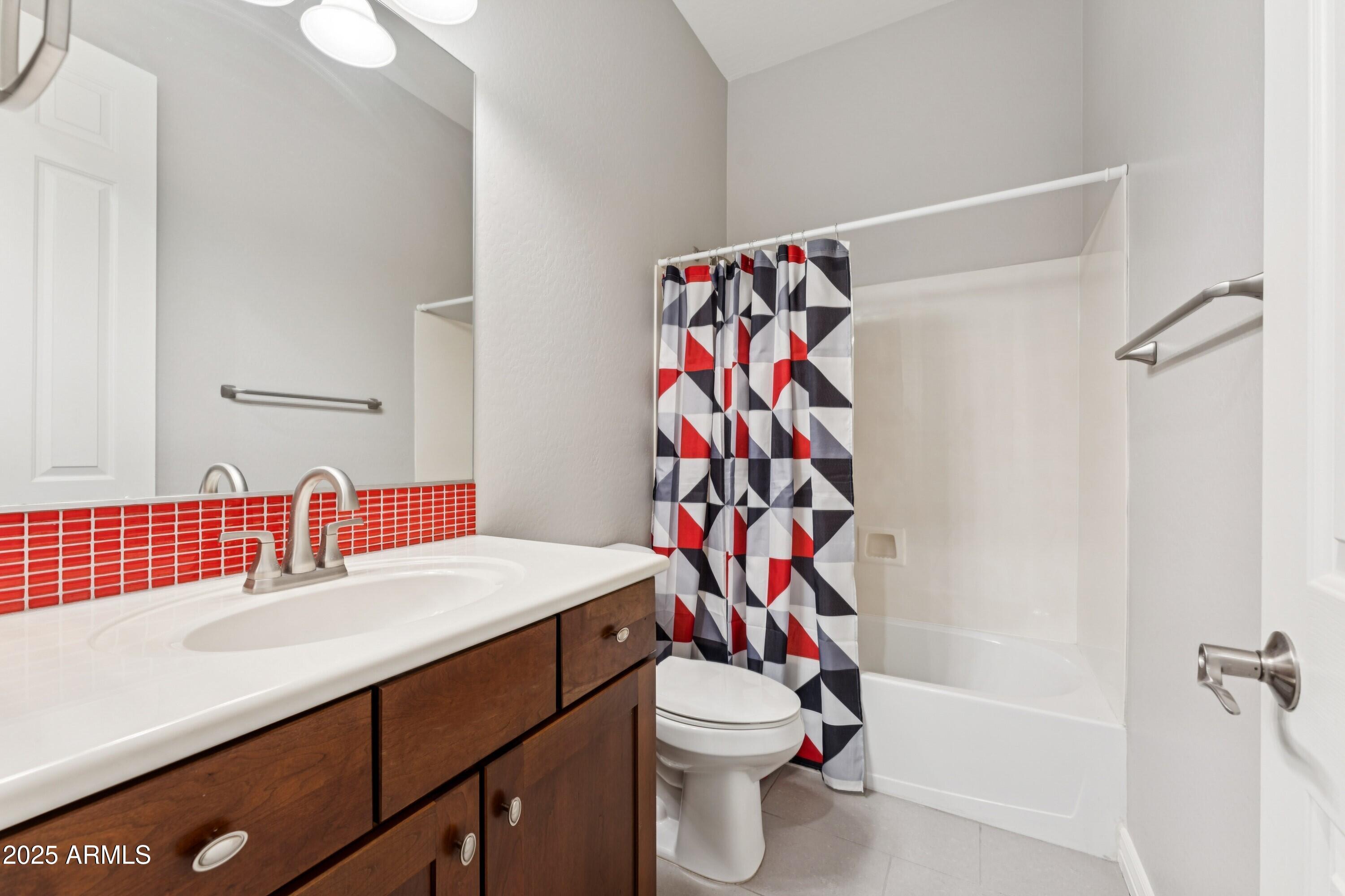 9916 West Redbird Road Peoria, AZ 85383 - Photo 28 of 96 a bathroom with a sink toilet and shower