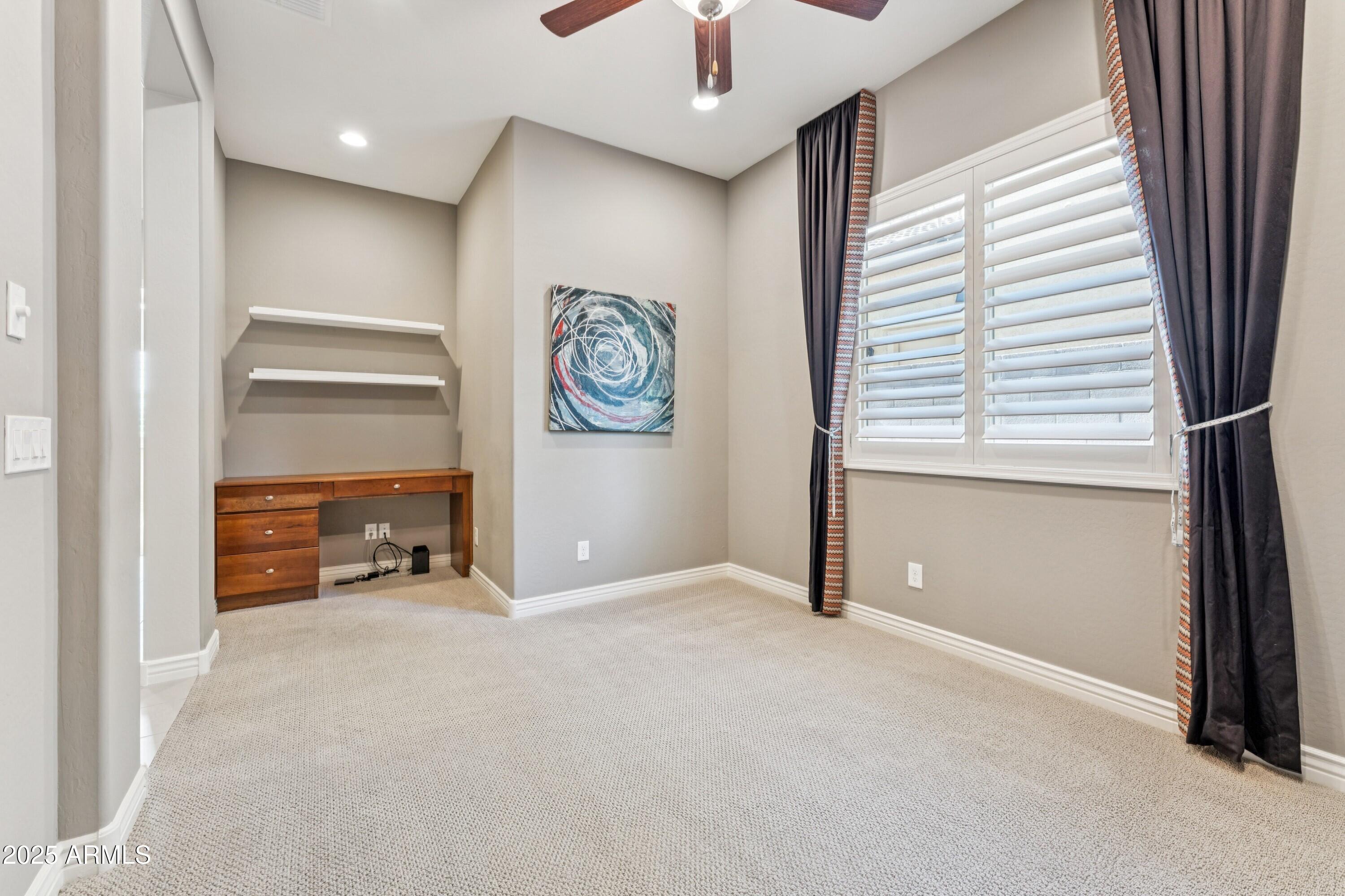 9916 West Redbird Road Peoria, AZ 85383 - Photo 30 of 96 an empty room with windows and closet