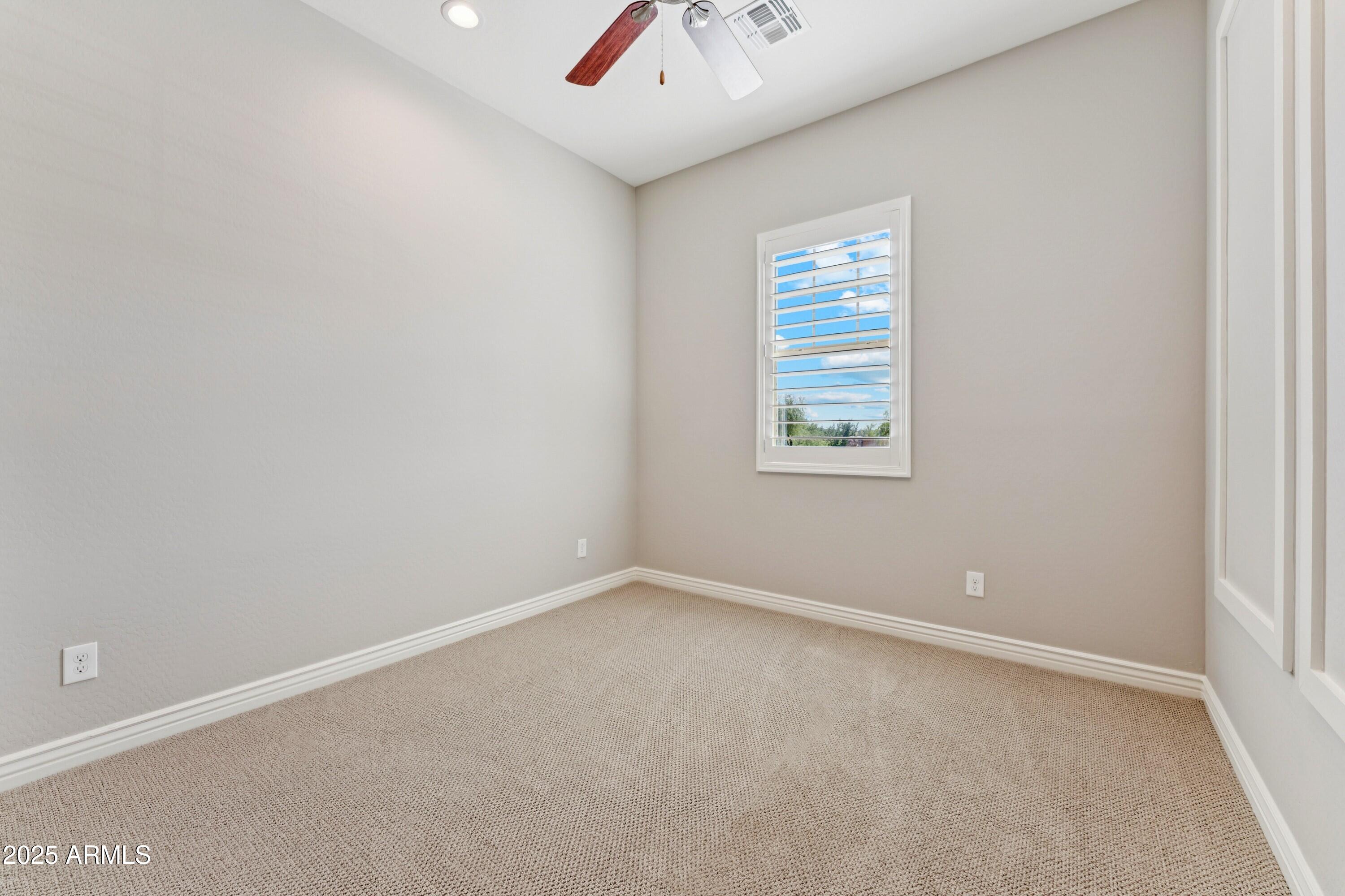 9916 West Redbird Road Peoria, AZ 85383 - Photo 31 of 96 an empty room with a window and a fan