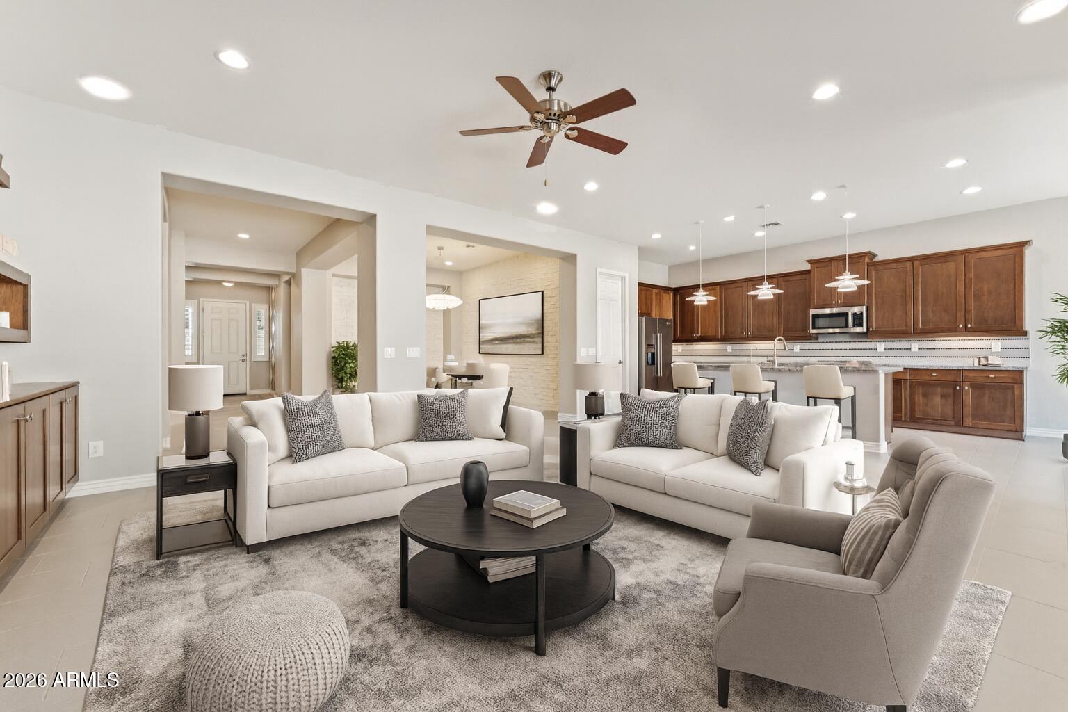 9916 West Redbird Road Peoria, AZ 85383 - Photo 4 of 96 a living room with furniture kitchen and a chandelier