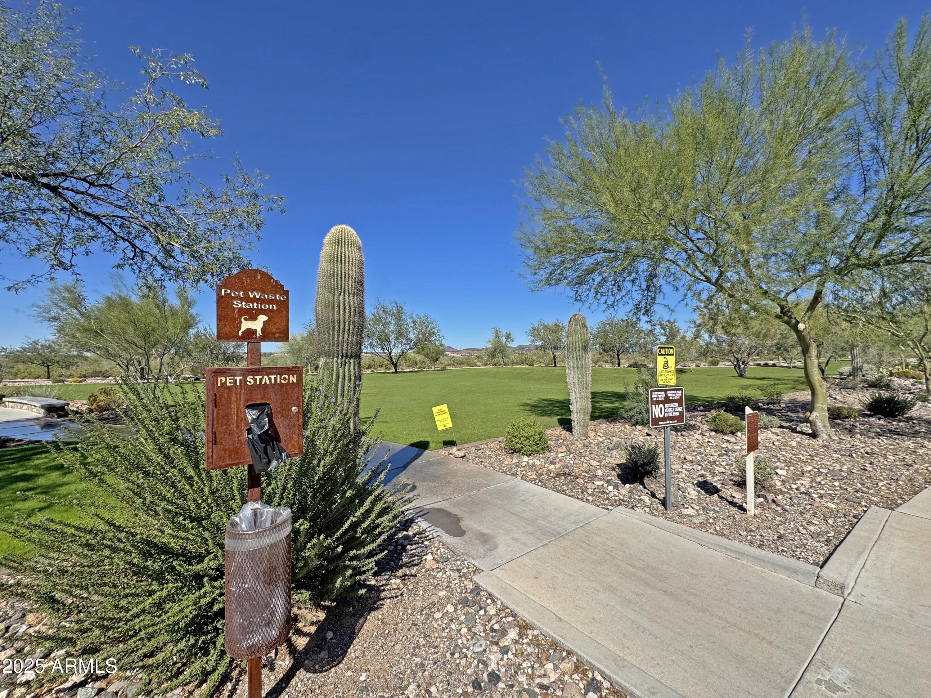 9916 West Redbird Road Peoria, AZ 85383 - Photo 46 of 96 a view of a lake with a table and chairs under an umbrella