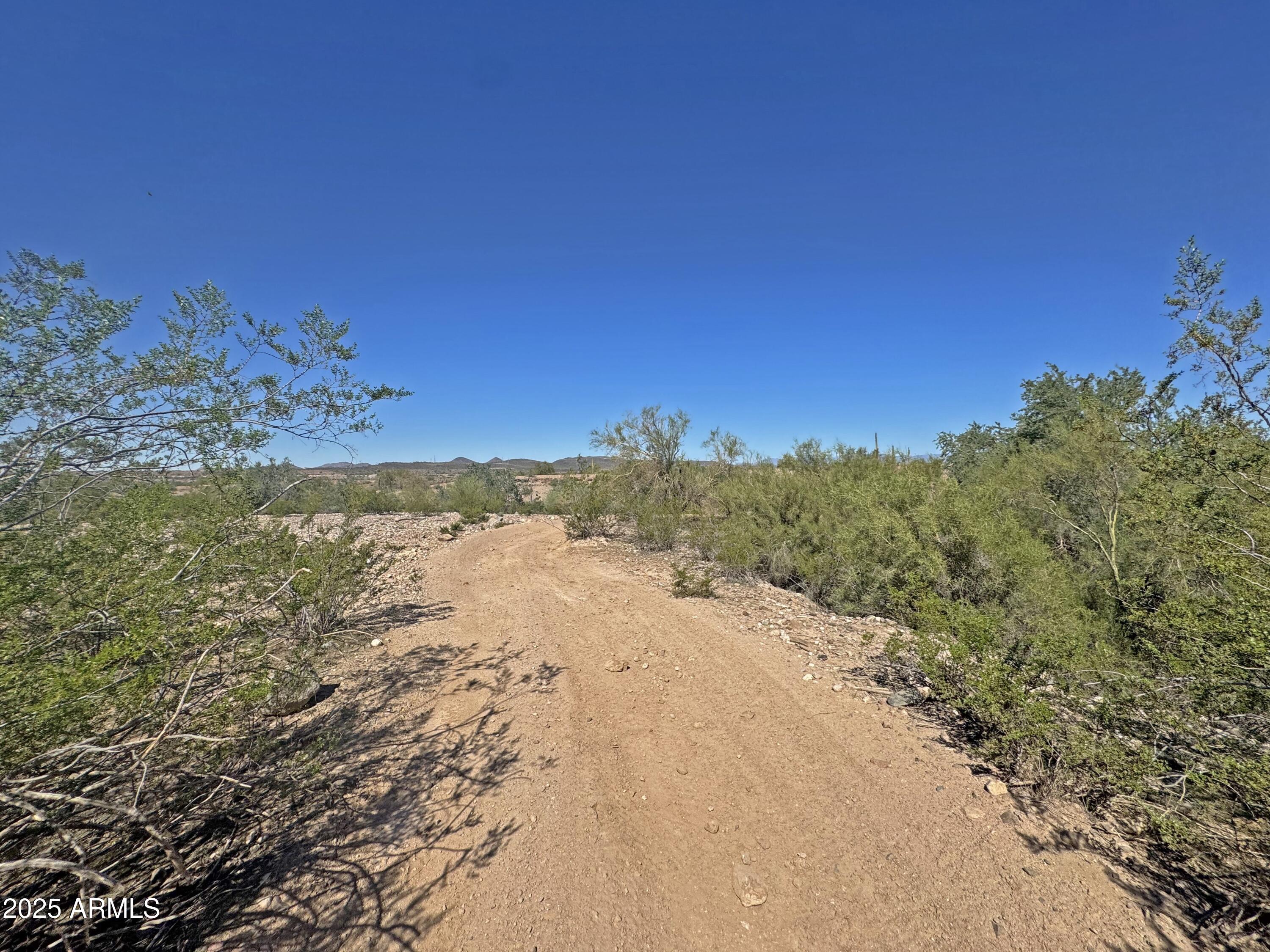 9916 West Redbird Road Peoria, AZ 85383 - Photo 68 of 96 a view of a beach with a mountain in the background