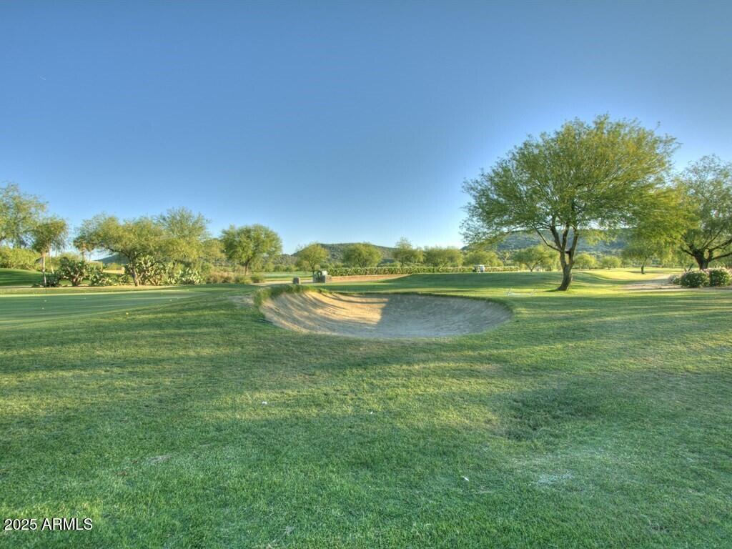 9916 West Redbird Road Peoria, AZ 85383 - Photo 94 of 96 a view of a golf course with a lake