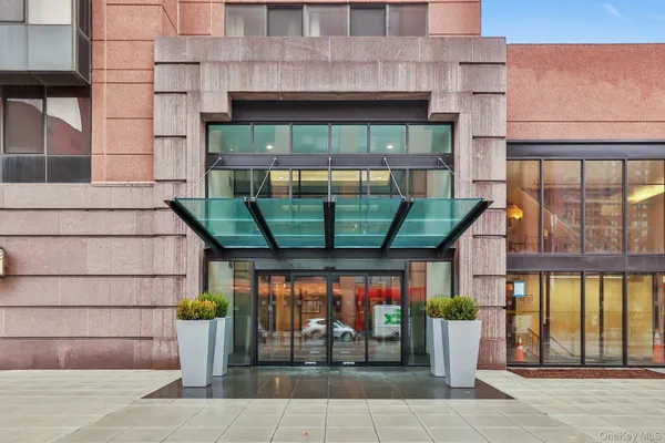 a front view of a building with glass windows and door