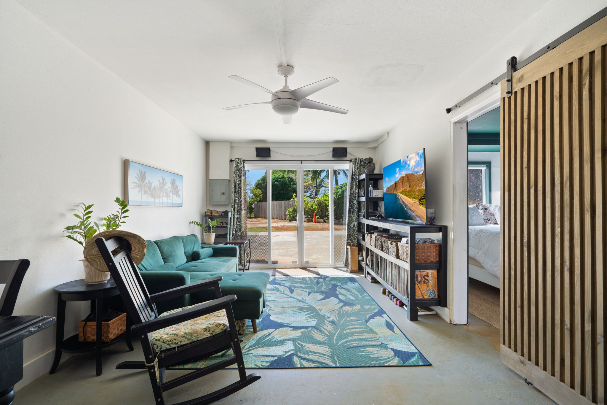 6100 Kawaihau Road Kapaa, HI 96746 - Photo 20 of 22 a living room with furniture a flat screen tv and a floor to ceiling window