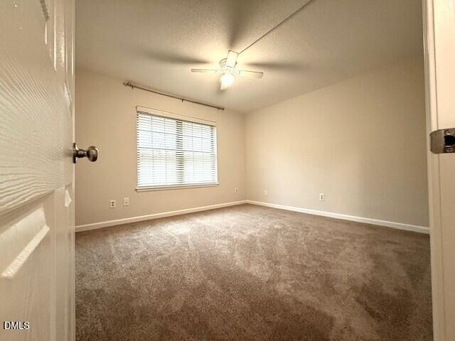 5800 Falls Of Neuse Road, Unit A Raleigh, NC 27609 - Photo 13 of 32 an empty room with chandelier fan and windows