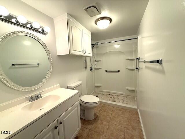 5800 Falls Of Neuse Road, Unit A Raleigh, NC 27609 - Photo 14 of 32 a bathroom with a sink mirror vanity and toilet