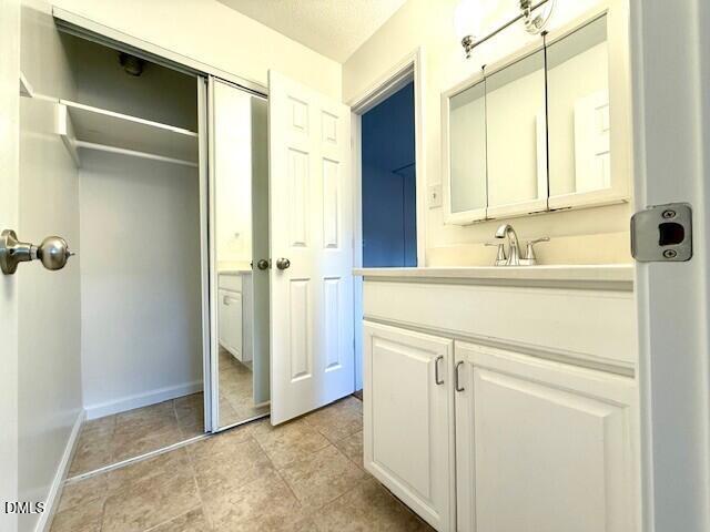 5800 Falls Of Neuse Road, Unit A Raleigh, NC 27609 - Photo 17 of 32 a bathroom with a sink and a mirror