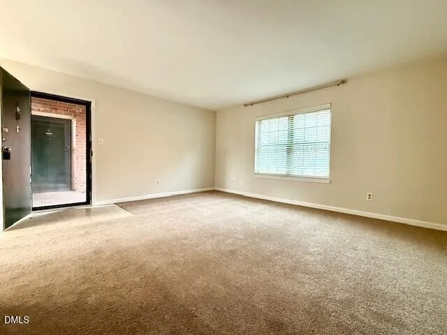an empty room with a empty space and windows