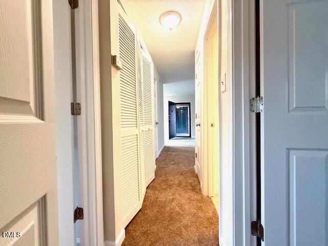 5800 Falls Of Neuse Road, Unit A Raleigh, NC 27609 - Photo 24 of 32 a view of a hallway with wooden floor and staircase