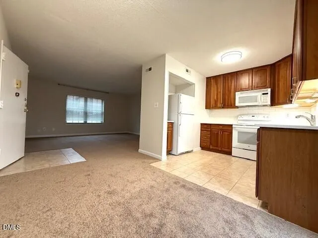 a view of a kitchen with a sink cabinets and a kitchen counter space