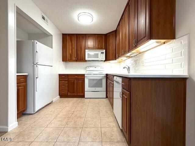 5800 Falls Of Neuse Road, Unit A Raleigh, NC 27609 - Photo 6 of 32 a kitchen with stainless steel appliances granite countertop a sink and a refrigerator