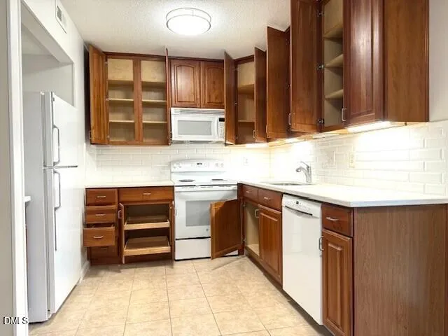 a kitchen with stainless steel appliances sink cabinets and window