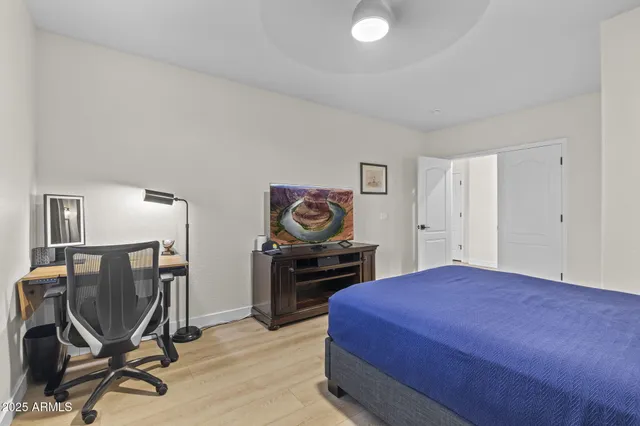 a bedroom with a bed and a television