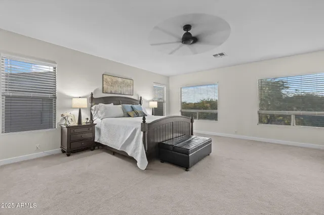 a bathroom with double vanity sinks a toilet and a mirror