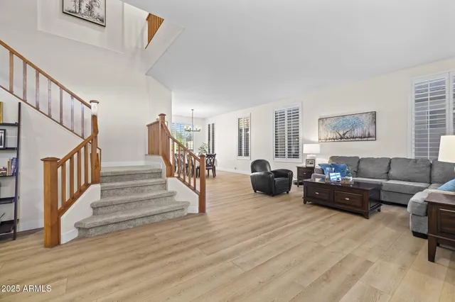 a kitchen with stainless steel appliances granite countertop wooden cabinets a sink a stove a refrigerator and island