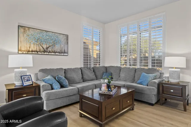 a kitchen with stainless steel appliances granite countertop a table chairs sink refrigerator and microwave