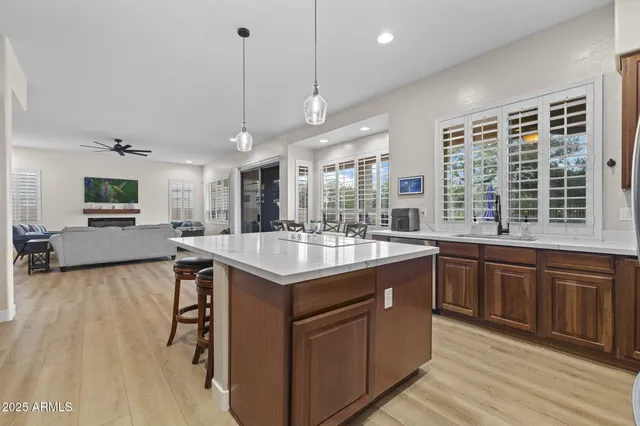 a living room with furniture a fireplace a flat screen tv and a large window