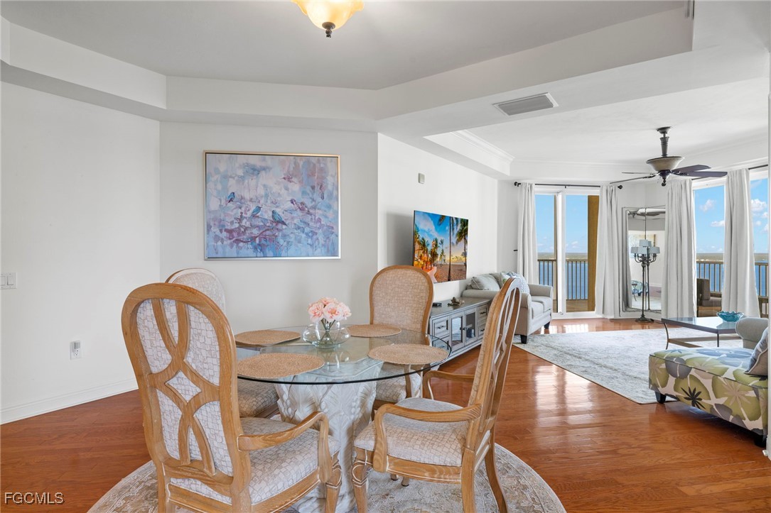 2745 First Street, Unit 2306 Fort Myers, FL 33916 - Photo 13 of 31 a dining room with furniture and wooden floor