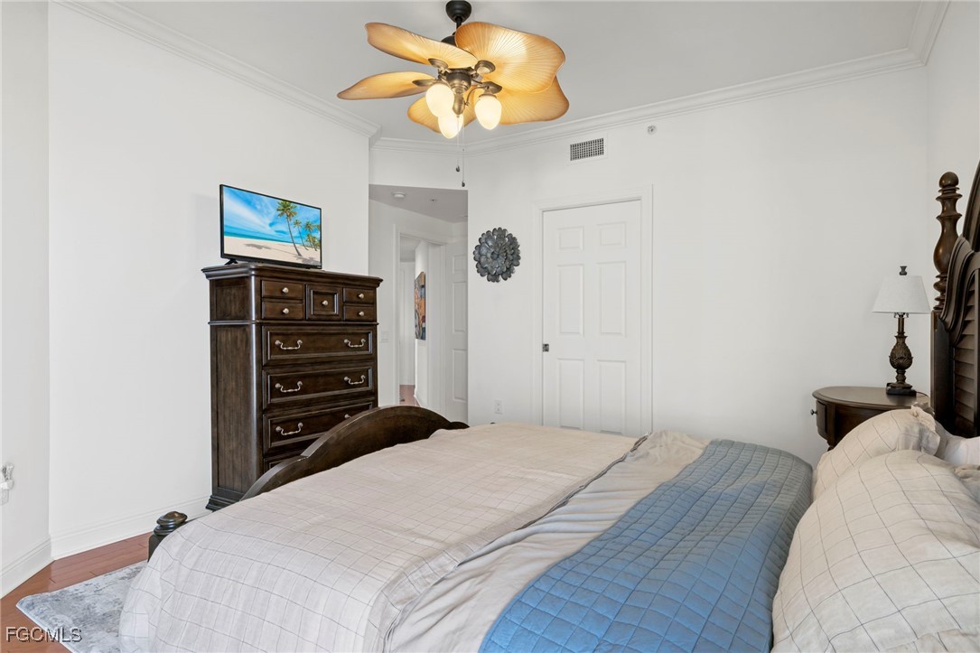 2745 First Street, Unit 2306 Fort Myers, FL 33916 - Photo 15 of 31 a bedroom with a bed and a chandelier