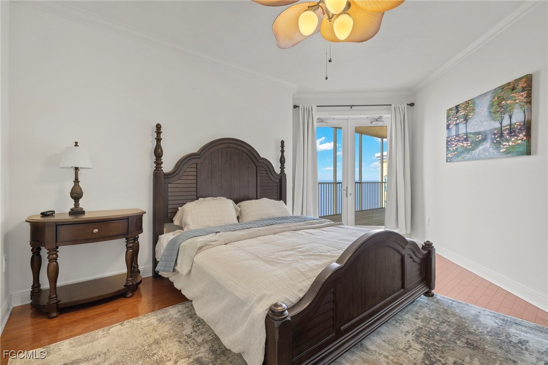 2745 First Street, Unit 2306 Fort Myers, FL 33916 - Photo 16 of 31 a bedroom with a bed and a chandelier
