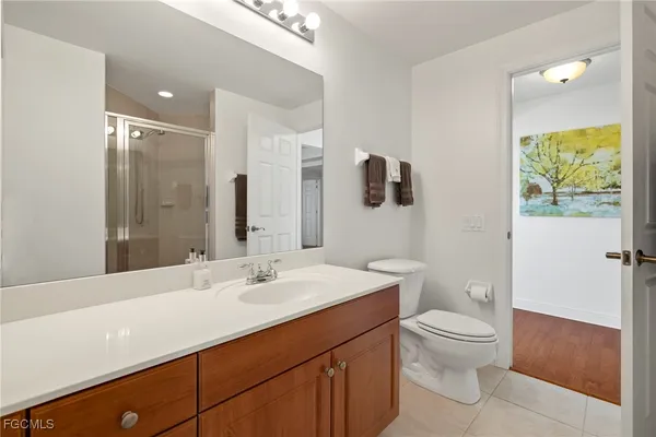 a bedroom with a bed and a large mirror