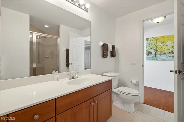 a bedroom with a bed and a large mirror