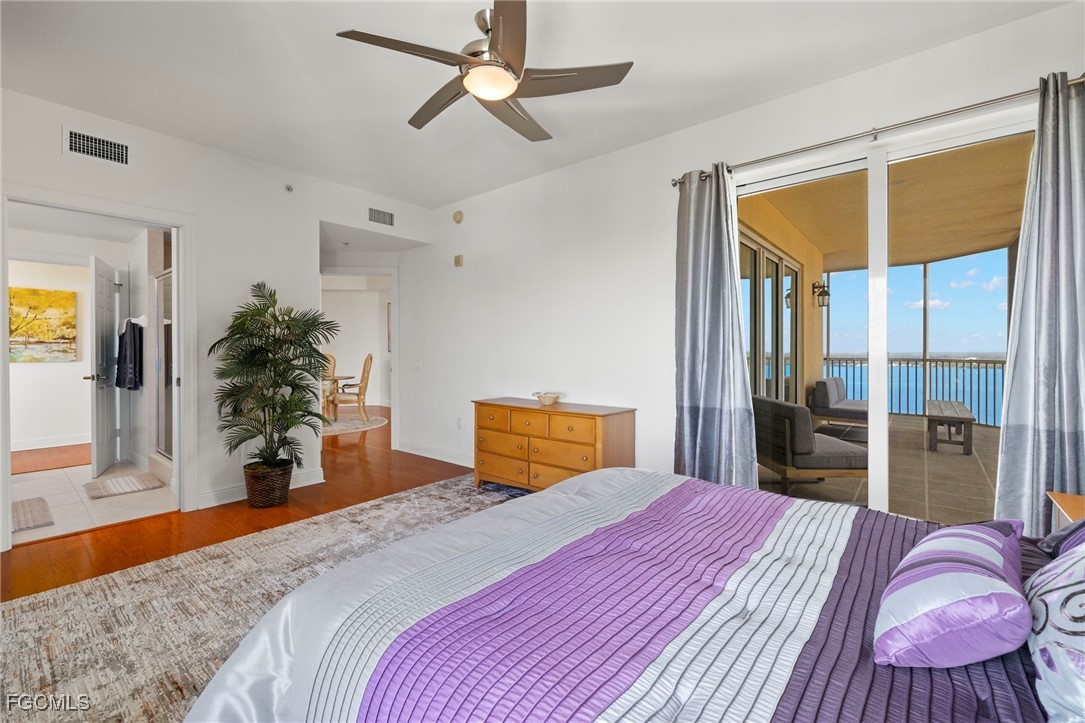 2745 First Street, Unit 2306 Fort Myers, FL 33916 - Photo 21 of 31 a bedroom with a bed and a large mirror