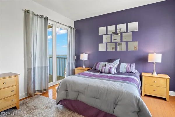 a bedroom with a bed and a painting on the wall