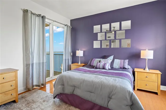 a bedroom with a bed and a painting on the wall