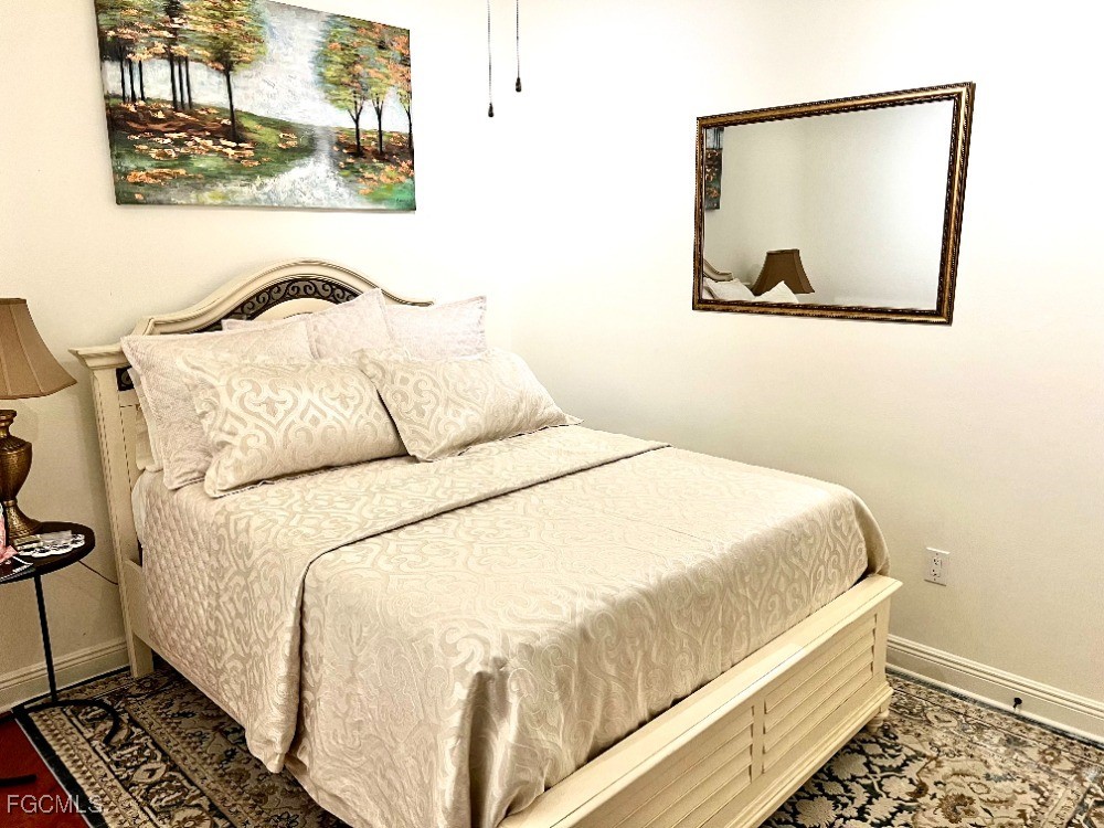 2745 First Street, Unit 2306 Fort Myers, FL 33916 - Photo 24 of 31 a bedroom with a bed and a painting on the wall