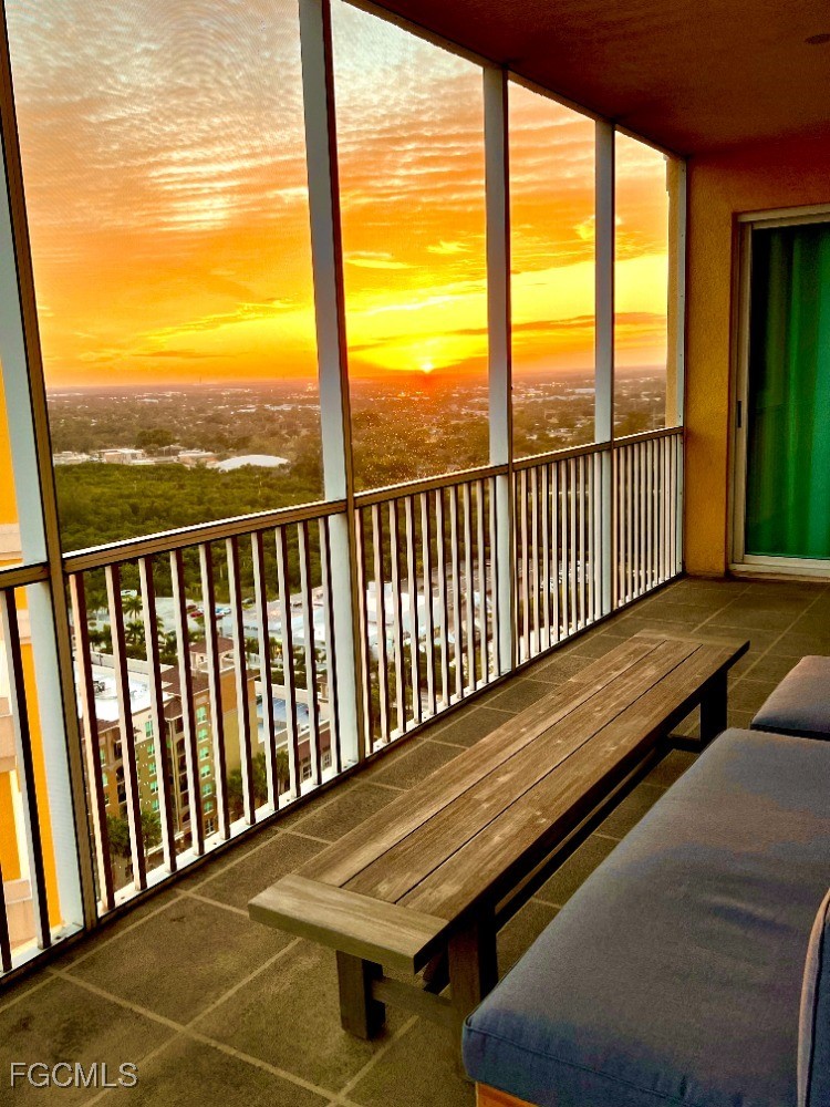 2745 First Street, Unit 2306 Fort Myers, FL 33916 - Photo 3 of 31 a view of a balcony with floor to ceiling windows with wooden floor