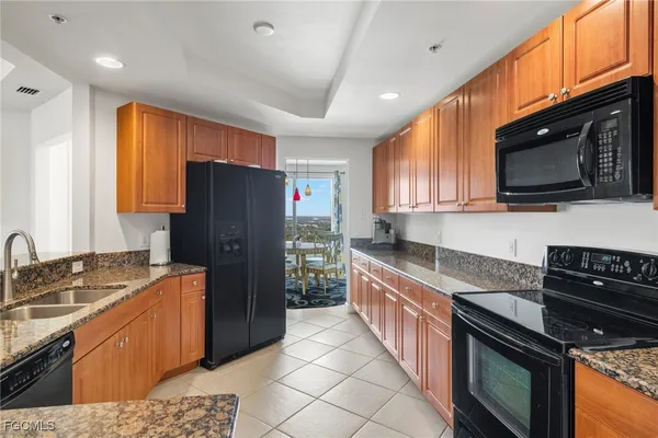 a kitchen with stainless steel appliances granite countertop a refrigerator and a sink
