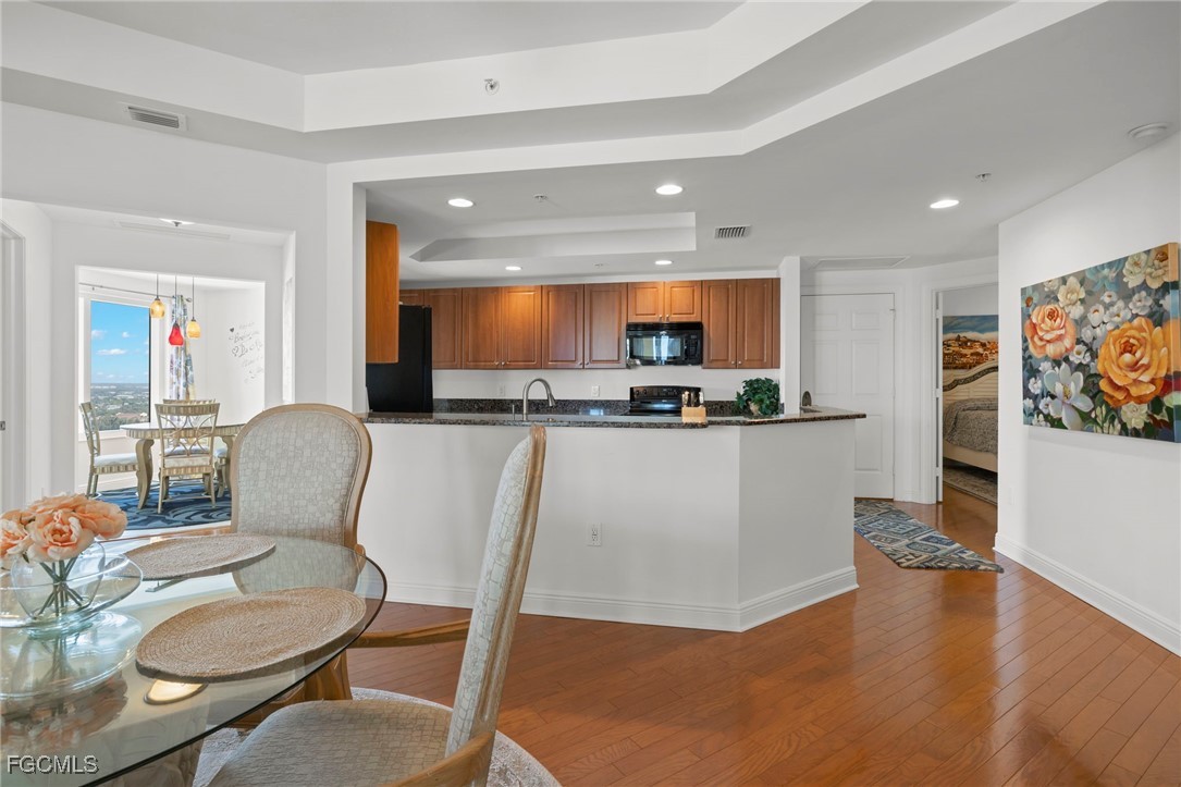 2745 First Street, Unit 2306 Fort Myers, FL 33916 - Photo 9 of 31 a living room with stainless steel appliances furniture a dining table and kitchen view