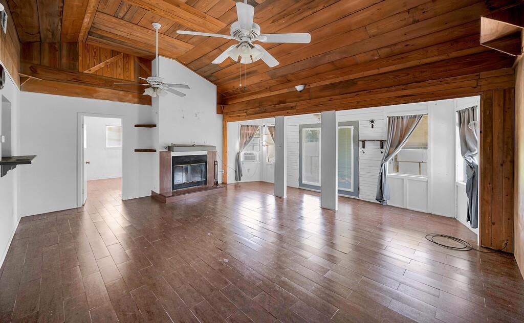 105 County Road 3590 China Spring, TX 76633 - Photo 3 of 30 a view of empty room with wooden floor and fireplace