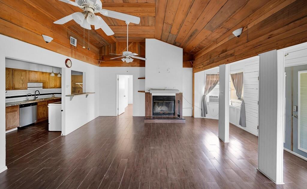 105 County Road 3590 China Spring, TX 76633 - Photo 4 of 30 a view of empty room with wooden floor and fireplace