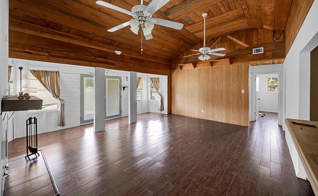 105 County Road 3590 China Spring, TX 76633 - Photo 5 of 30 a view of an empty room with wooden floor and a ceiling fan
