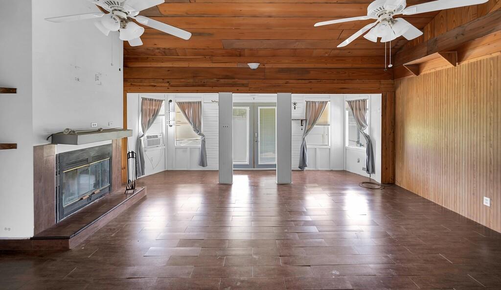 105 County Road 3590 China Spring, TX 76633 - Photo 6 of 30 a view of an empty room with wooden floor and a fireplace
