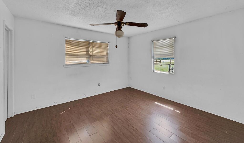 105 County Road 3590 China Spring, TX 76633 - Photo 8 of 30 a view of an empty room with a window and wooden floor