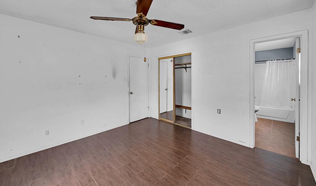 105 County Road 3590 China Spring, TX 76633 - Photo 9 of 30 an empty room with wooden floor and ceiling fan