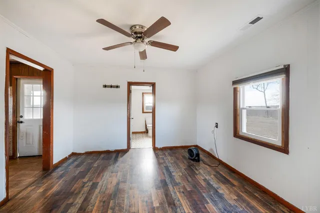 a view of a room with wooden floor