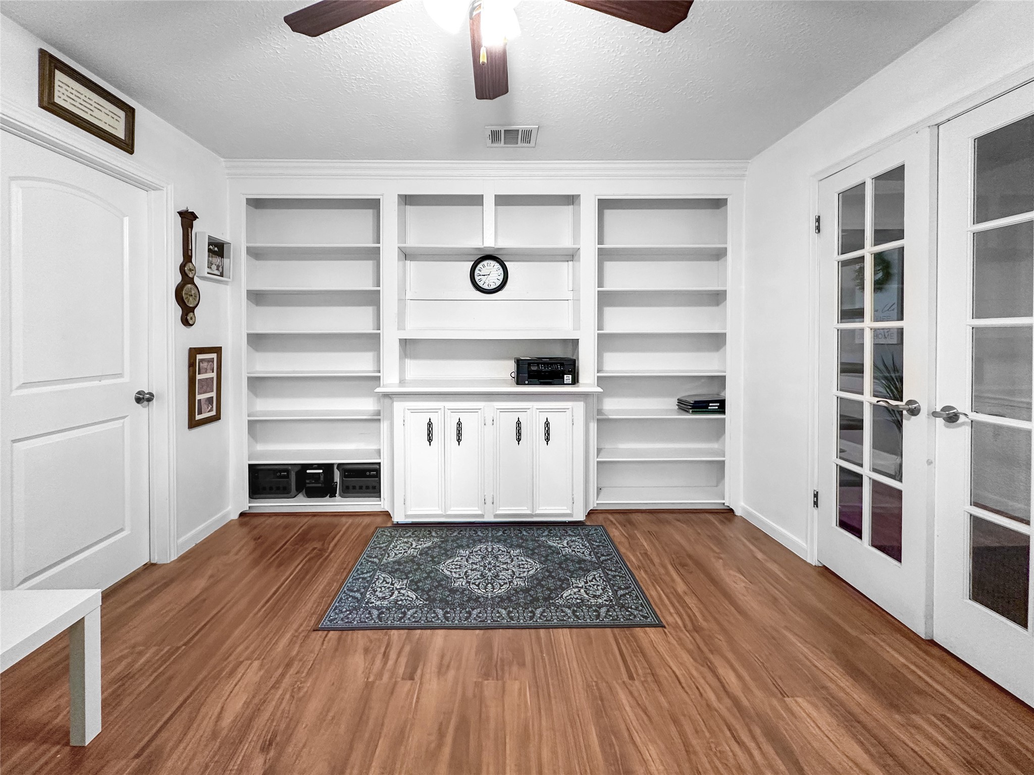 6511 Castle Pine Lane Spring, TX 77379 - Photo 13 of 49 Beautiful flex space with custom built-in shelving, rich flooring, and French doors—ideal for a home office, library, study, or media room.
