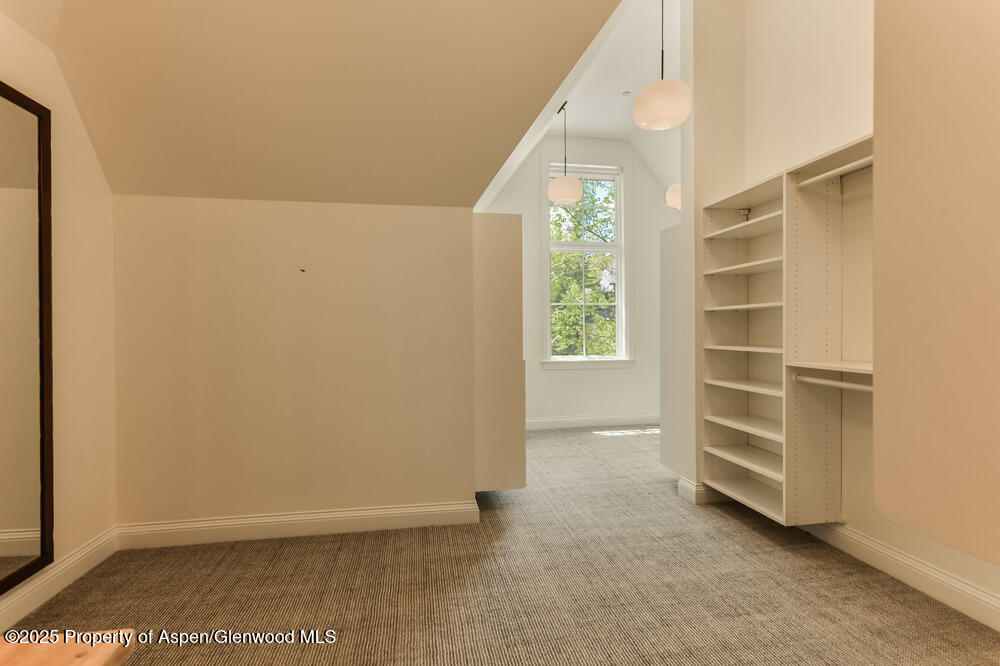 74 Pfister Drive, Unit 101 Aspen, CO 81611 - Photo 11 of 24 a view of an empty room with a window