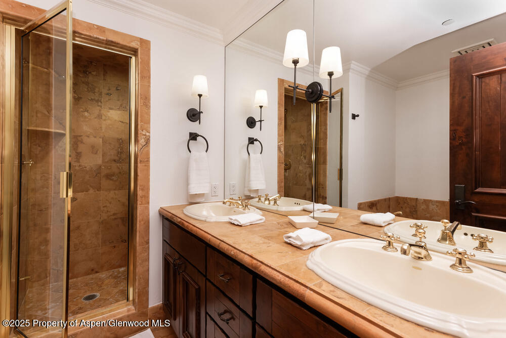 74 Pfister Drive, Unit 101 Aspen, CO 81611 - Photo 17 of 24 a bathroom with a sink and a mirror