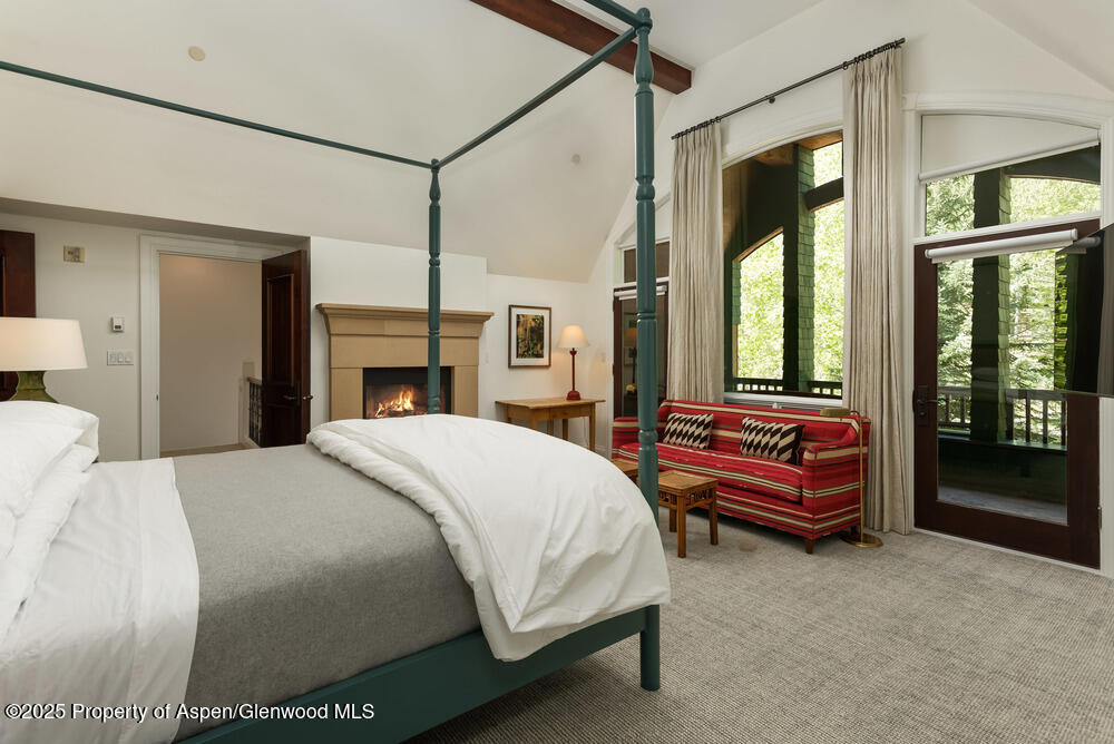 74 Pfister Drive, Unit 101 Aspen, CO 81611 - Photo 8 of 24 a bedroom with a bed and a chandelier