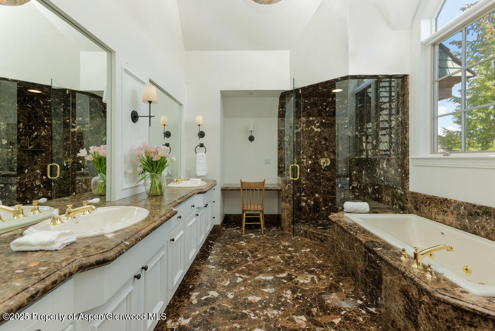74 Pfister Drive, Unit 101 Aspen, CO 81611 - Photo 10 of 24 a spacious bathroom with a granite countertop tub double vanity and a window
